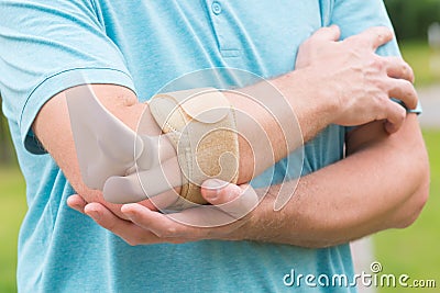 Man wearing elbow brace Stock Photo