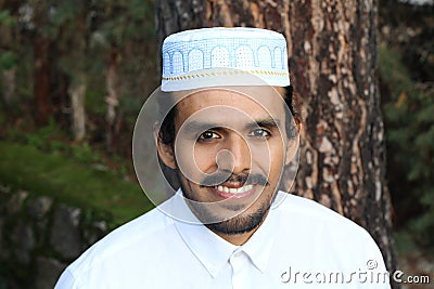 Man wearing embroidery pray skull cap Stock Photo