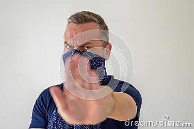 Man wearing a face guard holding up his hand Stock Photo