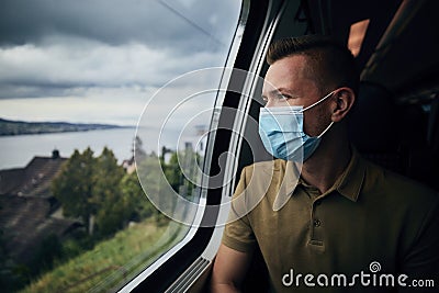 Man wearing face mask inside train Stock Photo