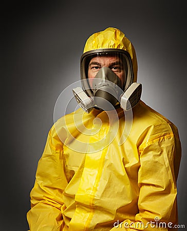 Man wearing a hazmat suit and mask Stock Photo