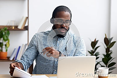 Man wearing headphones learn foreign language indoors Stock Photo