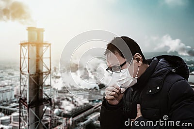 Man wearing mask against smog and air pollution factory background Stock Photo