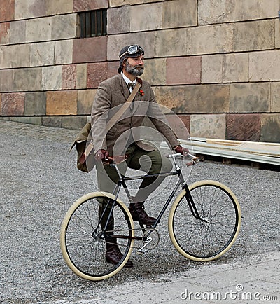 Man wearing old fashioned tweed clothes and bicycle Editorial Stock Photo