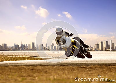 Man wearing safety suit riding sport racing motorcycle on sharp curve highway Stock Photo