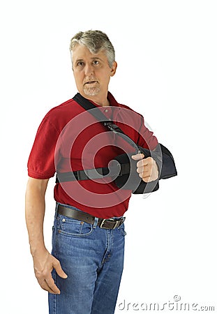 Man wearing a shoulder surgery sling with abduction pillow during recovery and healing Stock Photo