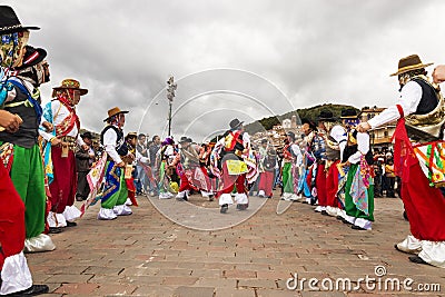 Man wearing traditional clothes and masks dancing the Huaylia in the Christmas day in front of the Cuzco Cathedral in Cuzco, Peru. Editorial Stock Photo