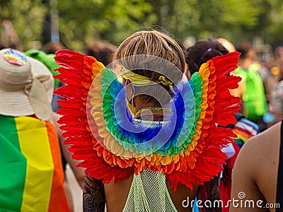 A man wears rainbow angel wings on Christopher Street Day CSD Editorial Stock Photo