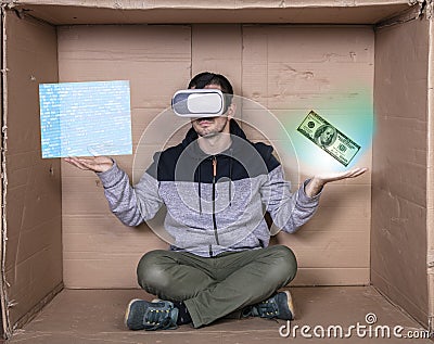 Man wears virtual reality glasses, shows that programming is equal to earnings Stock Photo