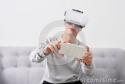 Man wears virtual reality glasses with smartphone inside. Stock Photo