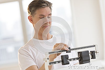 Man Weighing Himself On Balance Weight Scale Stock Photo