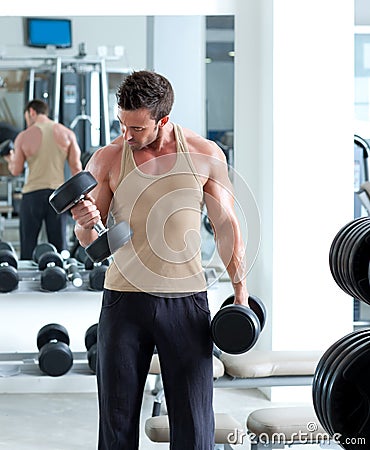 Man with weight training equipment on sport gym Stock Photo