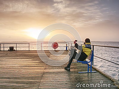 Man on wharf and photograph morning sea Stock Photo