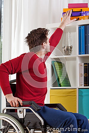 Man on wheelchair during everyday task Stock Photo