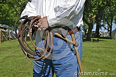 Man with whip and hatchet Stock Photo