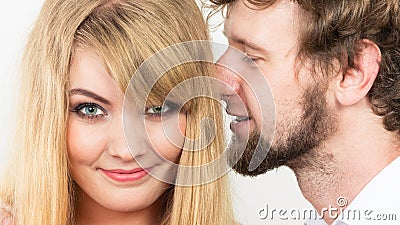 Man whispering to woman ear sharing secret. Stock Photo