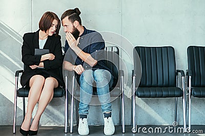 Man whispering woman ear office gossip secrets Stock Photo