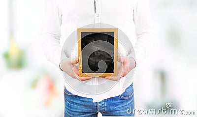 Man on a white background holds a black wooden board in his hands Stock Photo