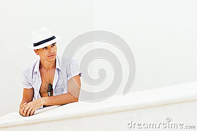 Man in a white hat next to the white wall Stock Photo