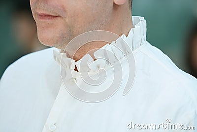 Man with white shirt with neck puff before Emporio Armani fashion show, Milan Fashion Week street style on June Editorial Stock Photo