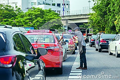 A man who selling flower garland to a taxi Editorial Stock Photo