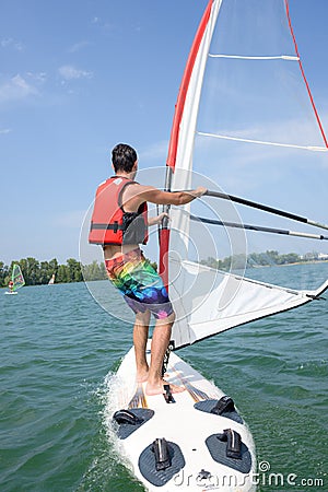 Man windsurfing on lake Stock Photo