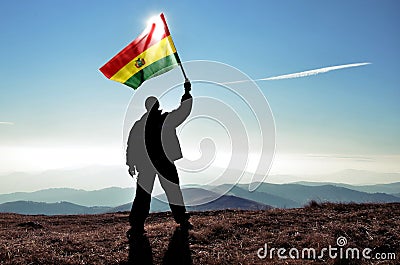 Man winner waving Bolivia flag on top of the mountain peak Stock Photo