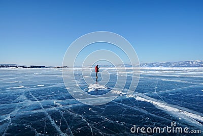 Man in winter jacket travel on frozen Baikal lake in Irkutsk, russia in early February Editorial Stock Photo