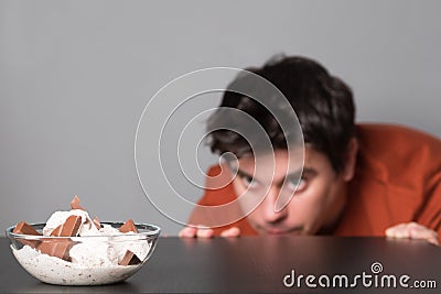 Man wishes to get himself some ice cream. Young man eating ice cream with chocolate. Junk food ice cream and chocolate Stock Photo