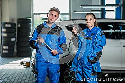 Man and woman in auto mechanics Stock Photo