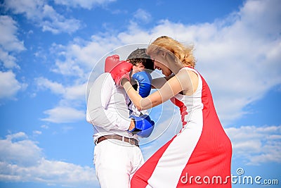 Man and woman boxing gloves fight sky background. She knows how to defend herself. Girl confident in strength power Stock Photo