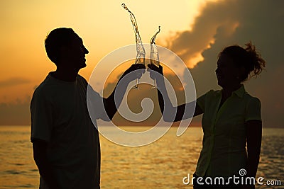 Man and woman clink glasses. Splashes of wine. Stock Photo