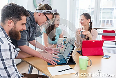 Man and woman cooperating as co-workers in collaborative office Stock Photo