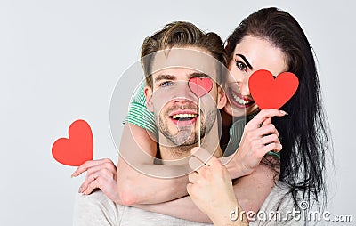 Man and woman couple in love hug and hold red heart valentines cards close up. Valentines day concept. Romantic ideas Stock Photo