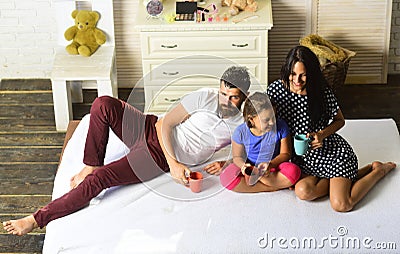 Man, woman and cute children smile and hold colorful cups Stock Photo