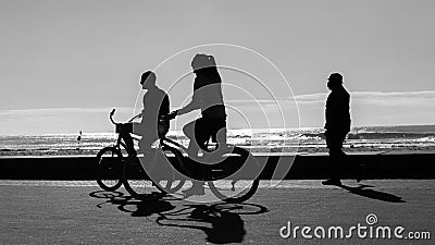 Man Woman Cycling Silhouetted Beach Ocean Editorial Stock Photo