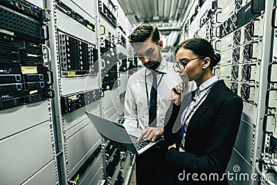 Man and woman in data centre Stock Photo