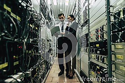 Man and woman in data centre Stock Photo