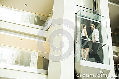 Man and woman in the elevator Stock Photo