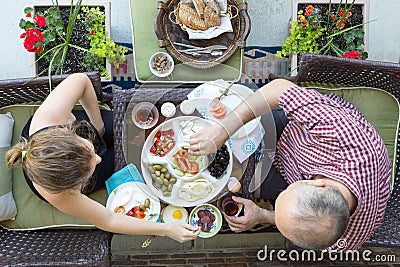 Man and woman enjoy an outdoor Turkish breakfast Stock Photo