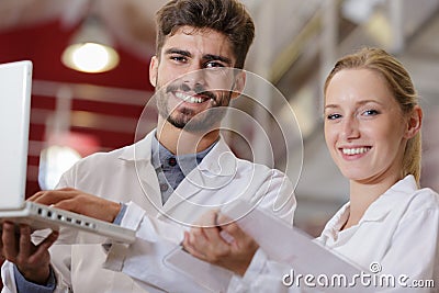 man and woman experts making tests in wine manufactory Stock Photo