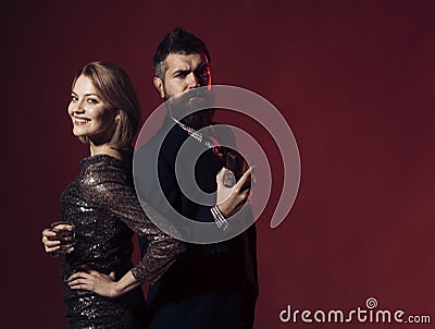 Man and woman in fancy clothes drink wiskey Stock Photo