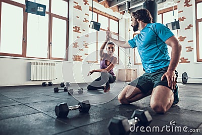 Man And Woman Giving High Five In Fitness Club Stock Photo