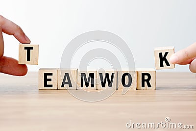 Man and woman hand building teamwork word on wooden cubes, success in business concept background Stock Photo