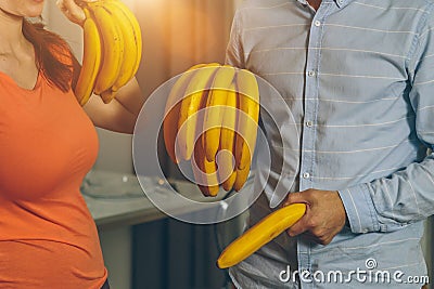 Man and woman holding bananas Stock Photo
