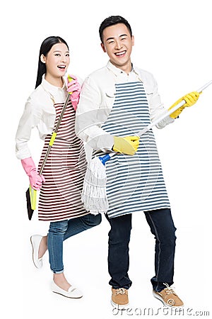 Man and woman holding cleaning supplies Stock Photo