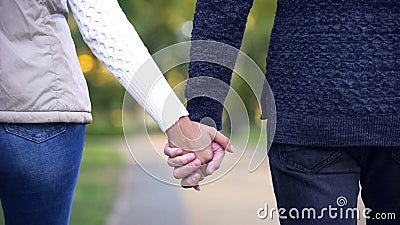 Man and woman holding hands back view, living life together, romantic date Stock Photo