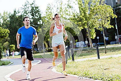 A man and a woman jogging Stock Photo