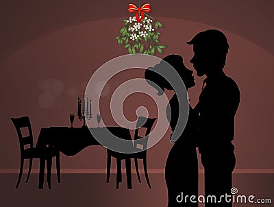 Man and woman kissing under the mistletoe Stock Photo