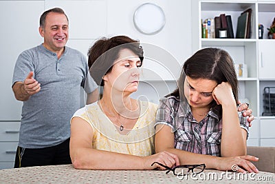 Man and woman listening to young woman and trying to help Stock Photo